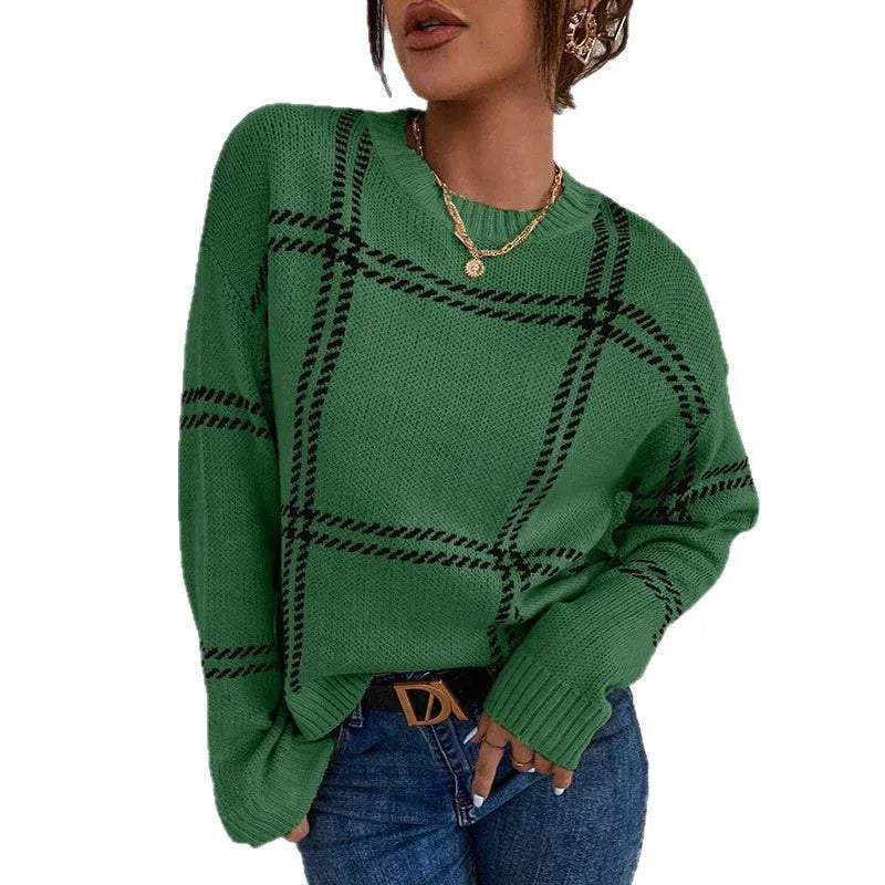 Women's loose fit crew neck sweater in a colour-block plaid pattern with apricot, black, beige, red, and green stripes.