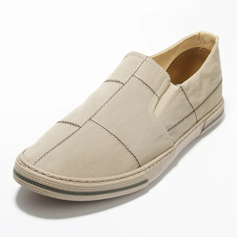 Men's low-top slip-on canvas shoes in khaki colour with a vulcanised rubber sole and rounded toe.