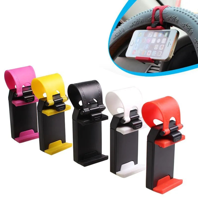 Black universal steering wheel phone holder clip mounted on a car steering wheel holding a smartphone.