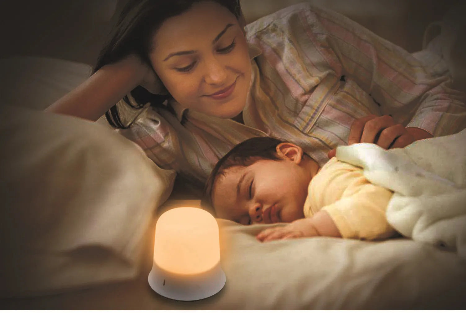 White rechargeable touch-control bedside night light with motion sensor on a table.