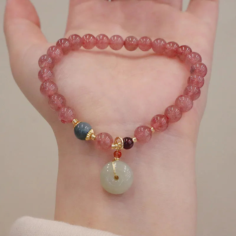 Natural strawberry quartz women's bracelet with geometric design, peace buckle closure, and lucky bagg purse charm attachment