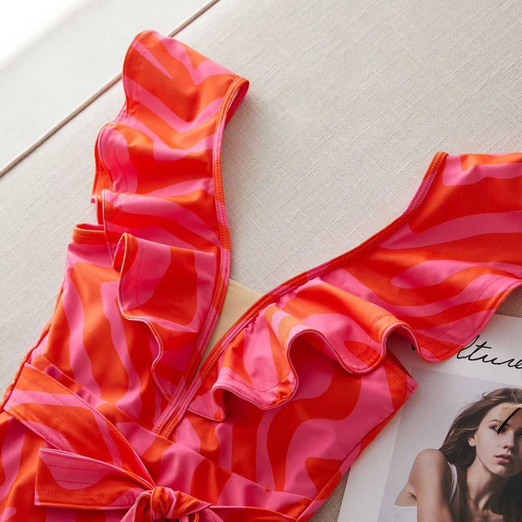 Women's printed one-piece swimsuit with double shoulder straps and a deep V neckline