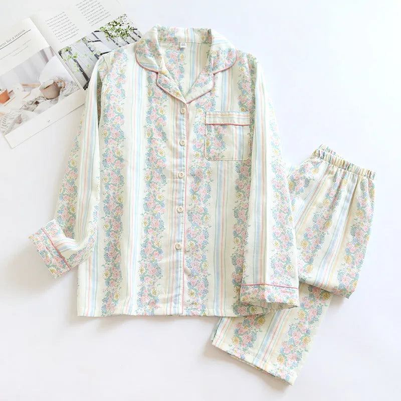Women's cotton gauze pyjama set with long sleeves and trousers in stripe and red fruit patterns.