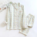 Women's cotton gauze pyjama set with long sleeves and trousers in stripe and red fruit patterns.