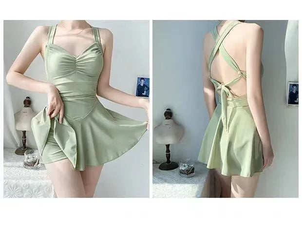 Women's avocado green boxer style one-piece backless swimsuit on a mannequin