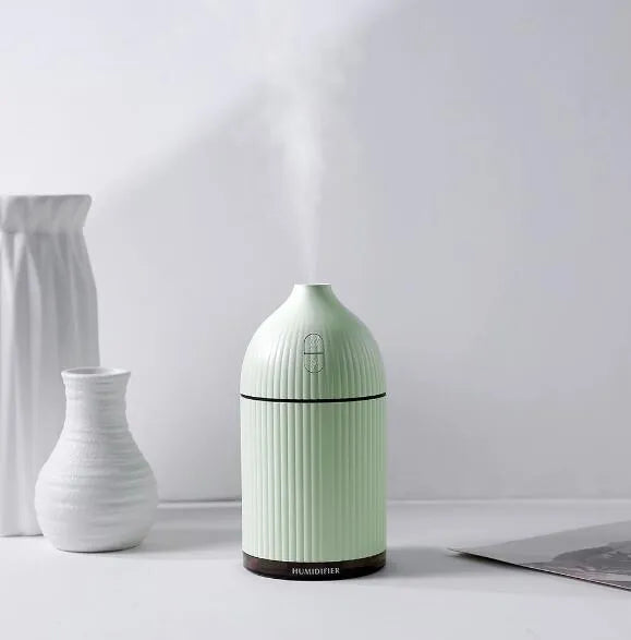 White ultrasonic aromatherapy diffuser with LED light, 300ml water tank, and USB cable.