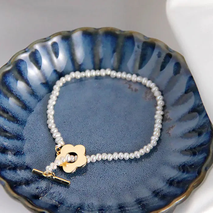 Sterling silver natural pearl flower bracelet with irregular pearl beads, handmade, adjustable size, on a white background