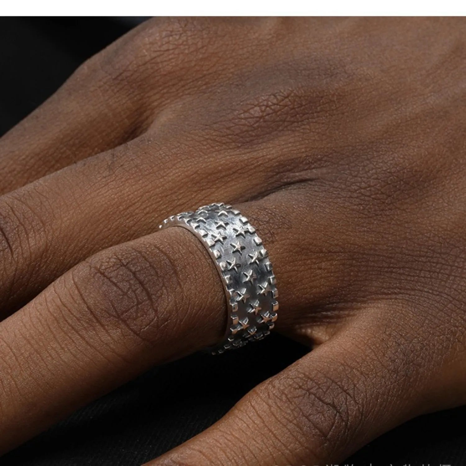 Sterling silver adjustable ring with a geometric pattern of multiple five-pointed stars.