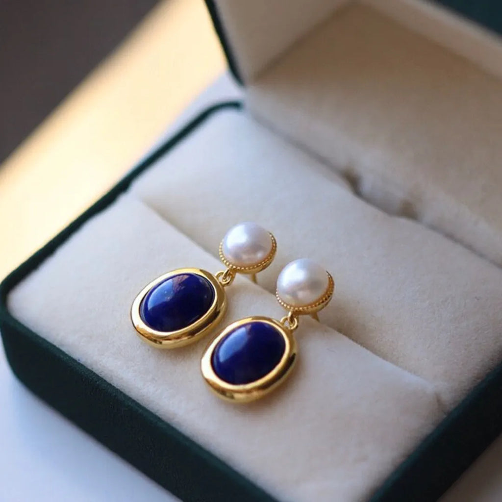 A pair of simple 925 silver drop earrings with a blue lapis lazuli pearl and auspicious patterns.