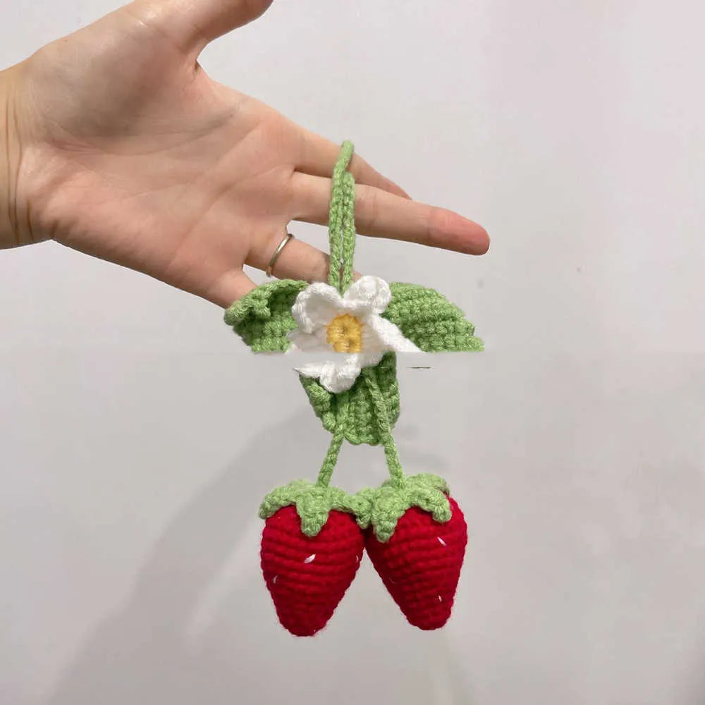 Handmade strawberry-shaped weaving pendant for car decoration made of cotton and hemp.