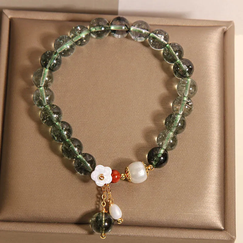 Green phantom quartz crystal bracelet with shell flower and Bells of Ireland design