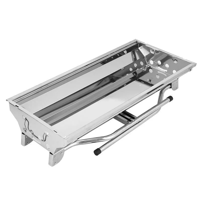 Large stainless steel turnover barbecue oven with charcoal grill and cooking accessories.