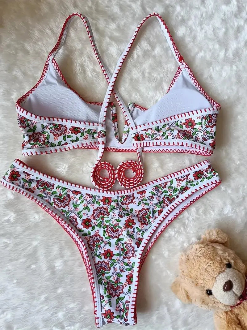 Women's V-neck swimsuit with floral embroidery in polyester fabric showing brief style cut