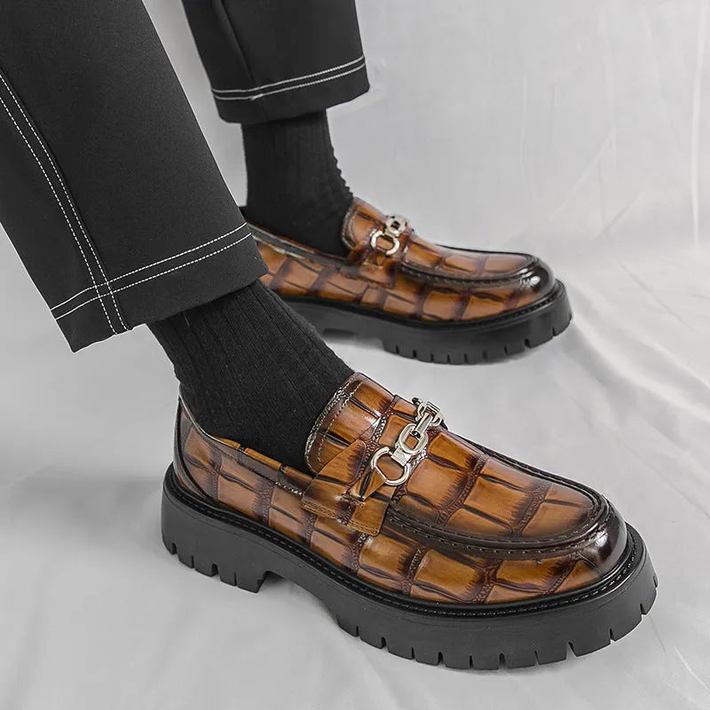 Men's black crocodile pattern leather loafers with a flat heel.