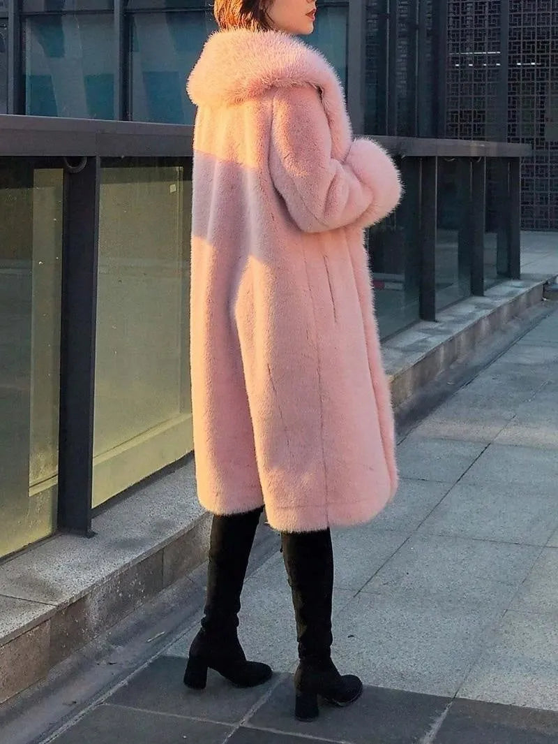 Woman wearing a thick grey faux rabbit fur mid-length coat with a fur collar.