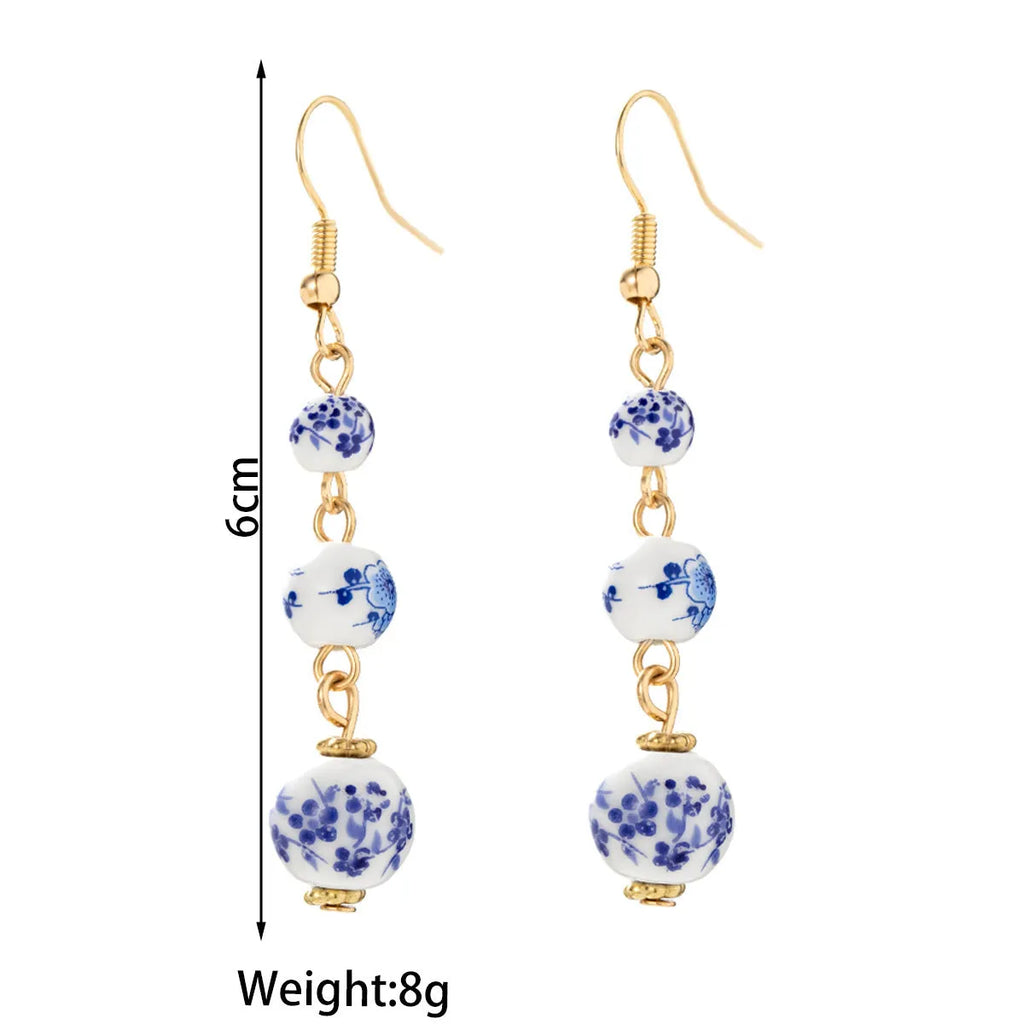 Blue and white porcelain ceramic bead earrings with geometric alloy elements in Chinese style design