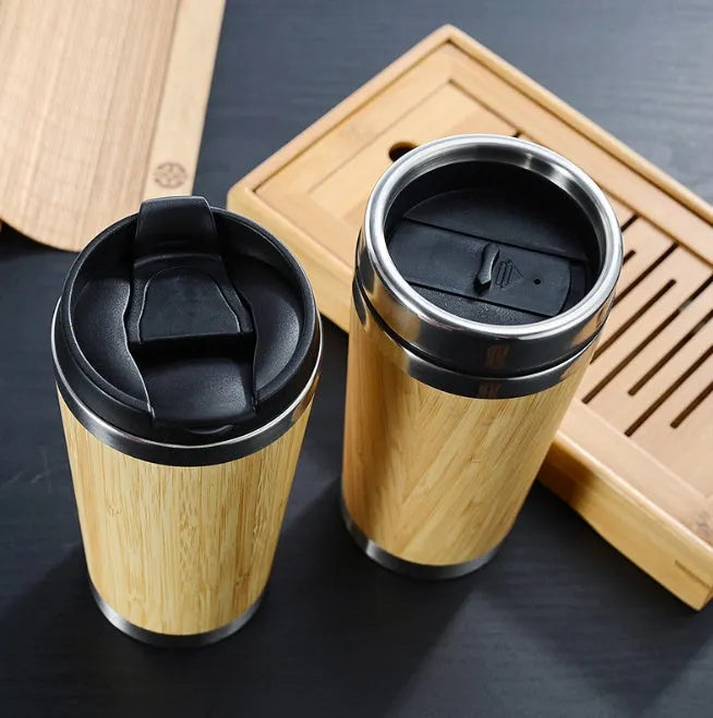 Bamboo and stainless steel insulated coffee cup with lid and foam pad, 420ml capacity.