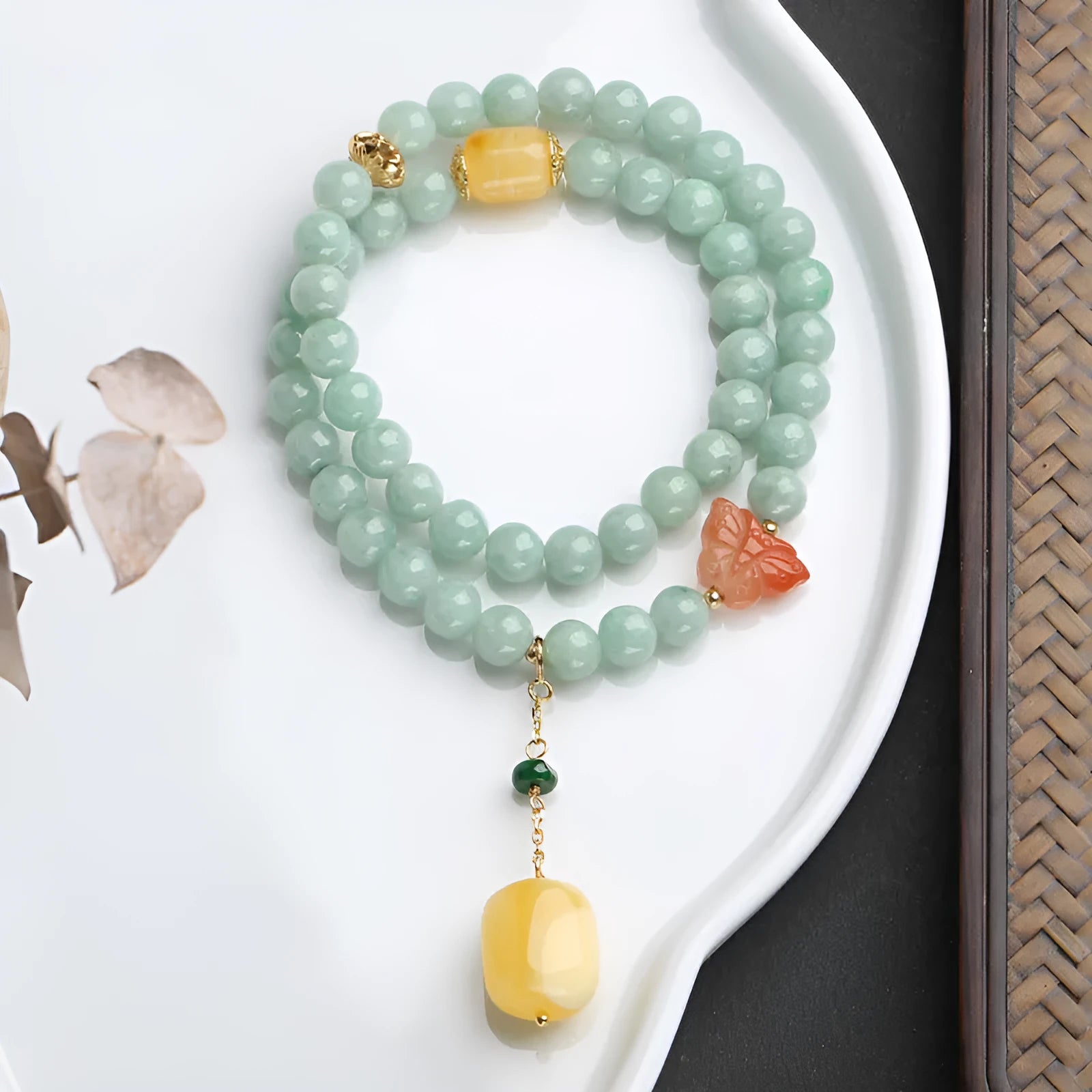 Close-up of a double-layer women's bracelet with green jade round beads and brown beeswax barrel beads in a geometric design.