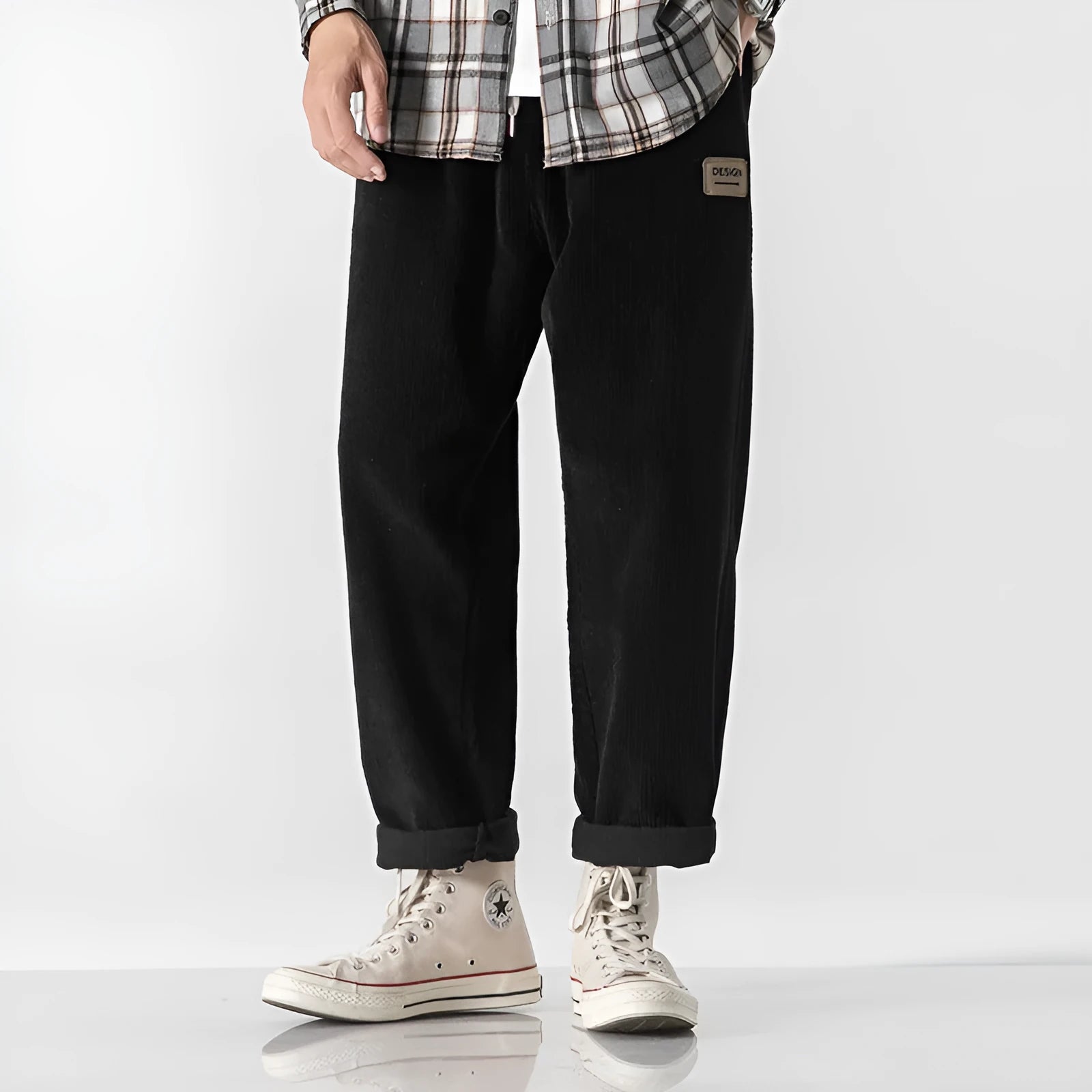 Men's loose straight-leg corduroy sports trousers in army green, laid flat to show fit and texture.