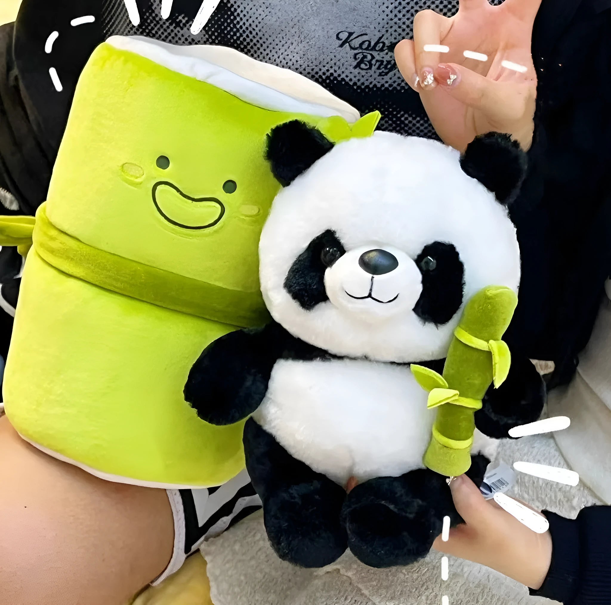 Black and white panda plush doll holding green bamboo tube, soft toy with PP cotton filling