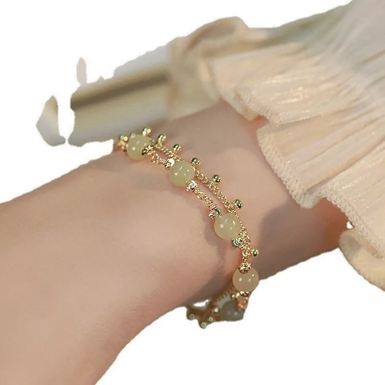 Handcrafted natural Hetian jade bracelet showing bead and charm style variations