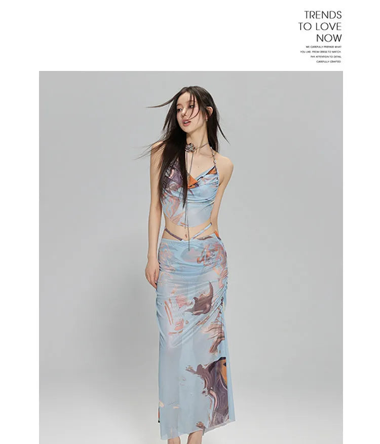 Blue printed women's three-piece bikini set with triangle top, high-waisted briefs, and skirt on hanger.