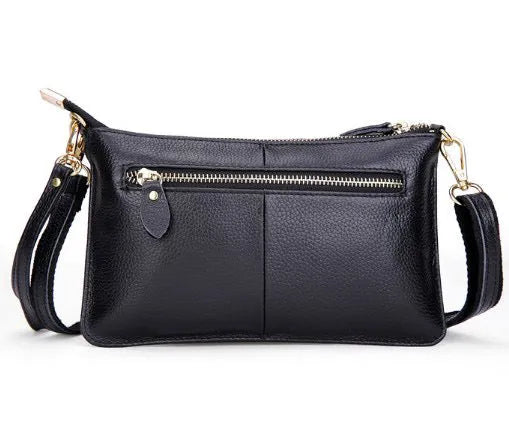 Cowhide ladies slant bag showing internal phone and certificate compartments with hand strap and shoulder strap