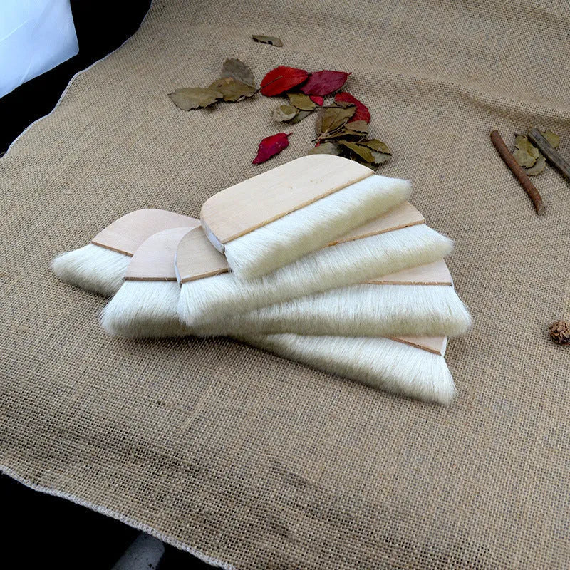 Wool brush for mounting diamond painting canvases, available in multiple sizes.