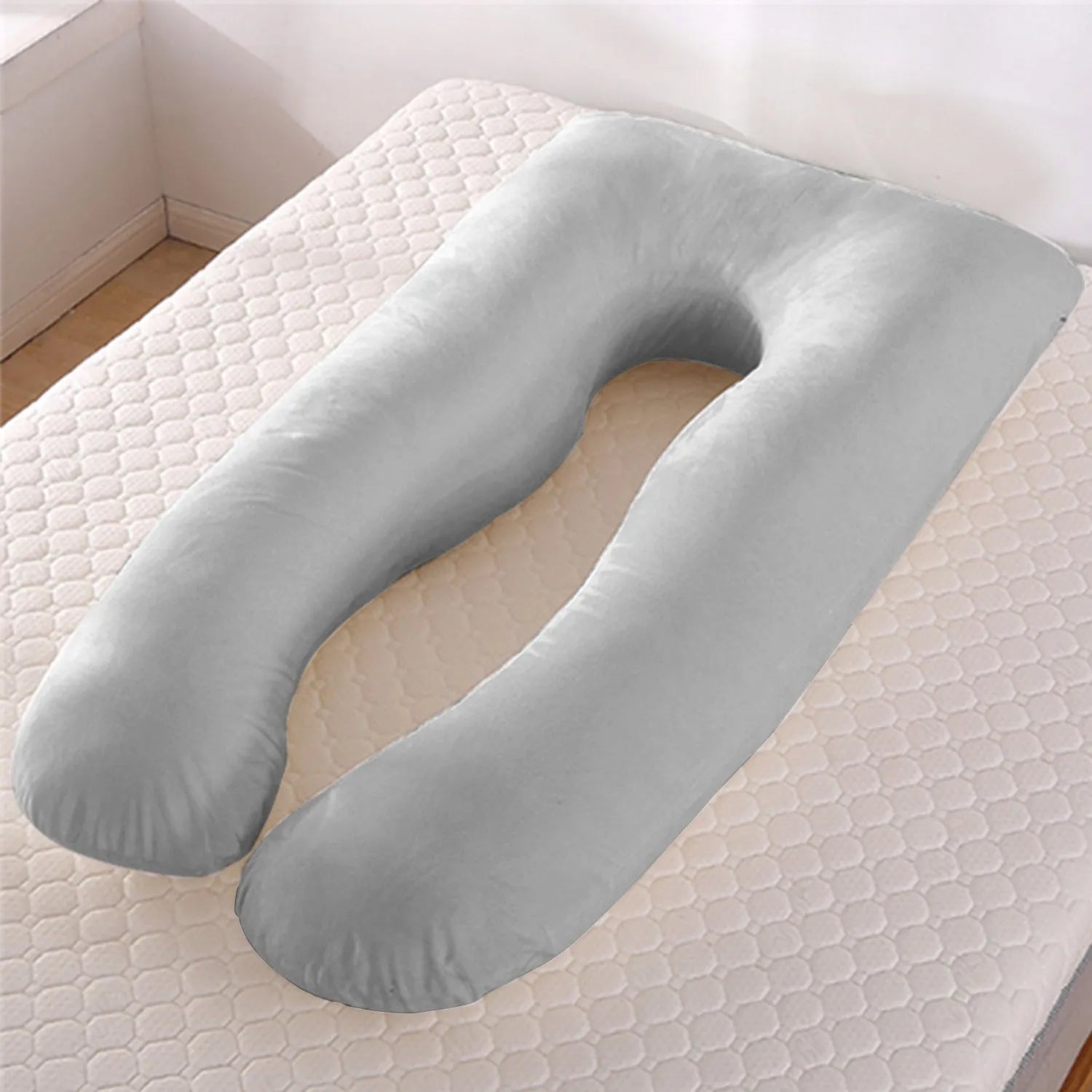 U-shaped pregnancy pillow in light blue ice silk fabric on a bed.