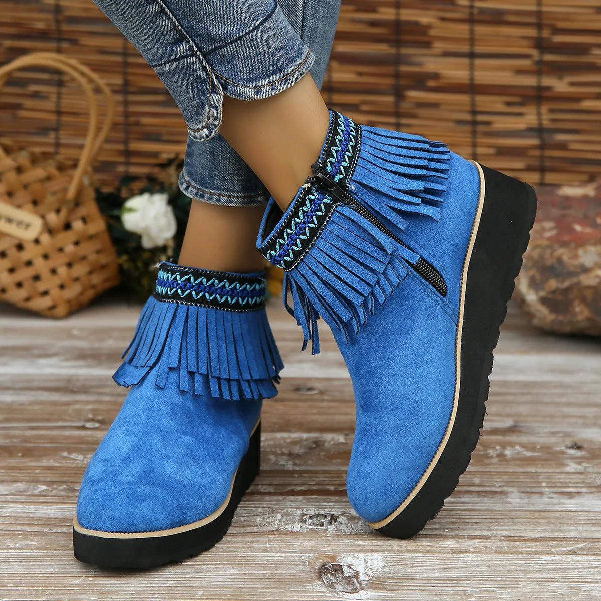 Women's dark brown suede ankle boots with wedge heel, platform sole, side zip, and tassel detail.