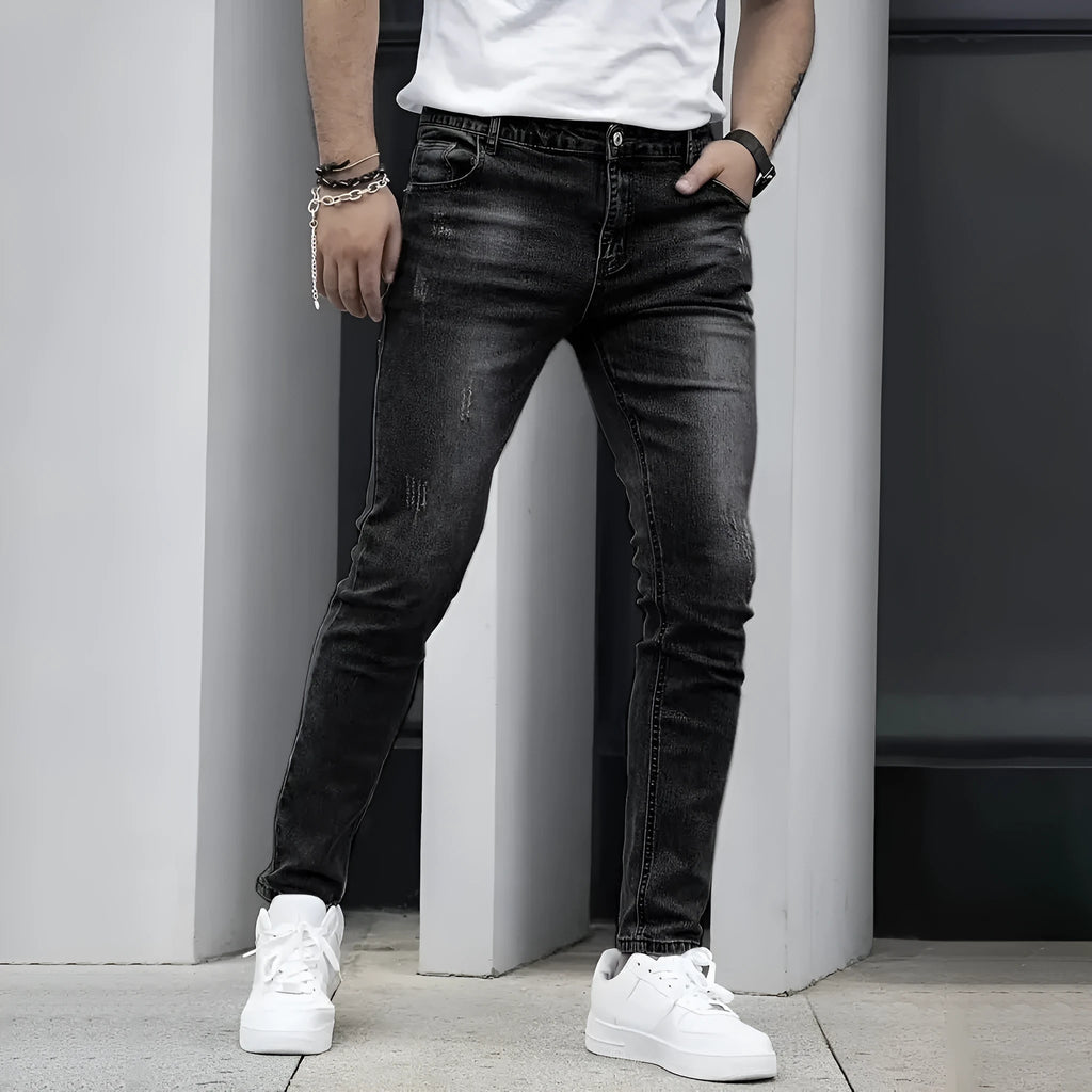 Men's black straight leg skinny stretch jeans with a mid waist and zipper fly.