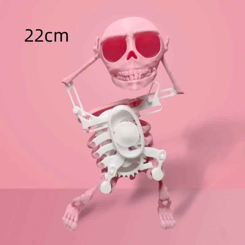 3D printed dancing skeleton gravity toy in pink and white, 22cm tall, on a desk