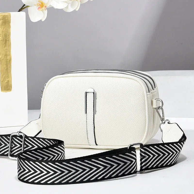 Soft PU leather women's oval crossbody bag showing slit pocket and internal organiser compartments