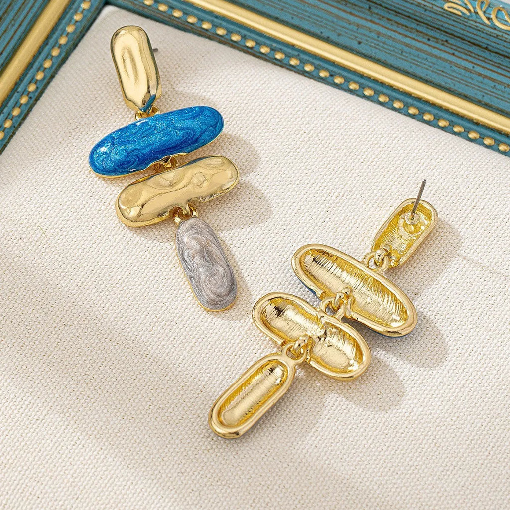 A pair of geometric-shaped stud earrings with a multicolour electroplated metal finish.