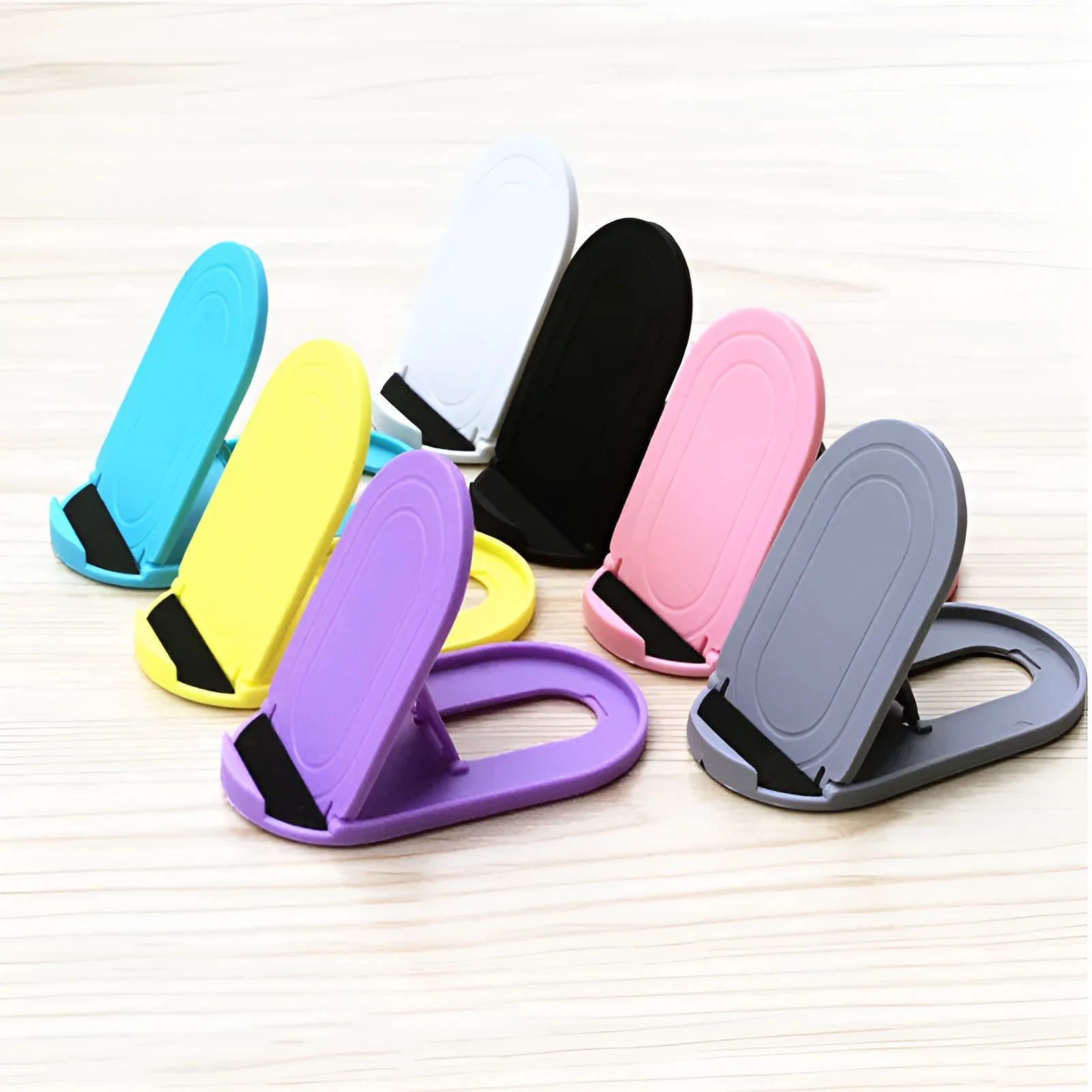 Plastic mobile phone stand in six colours showing 360-degree rotation feature