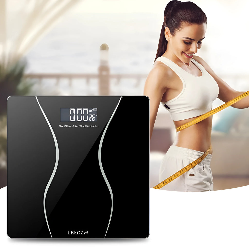 Black electronic bathroom scales with digital display showing weight measurement up to 180kg capacity