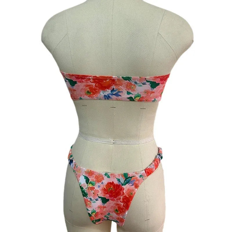 Women's floral print bikini set with lace trim on a backless tube top and matching briefs.