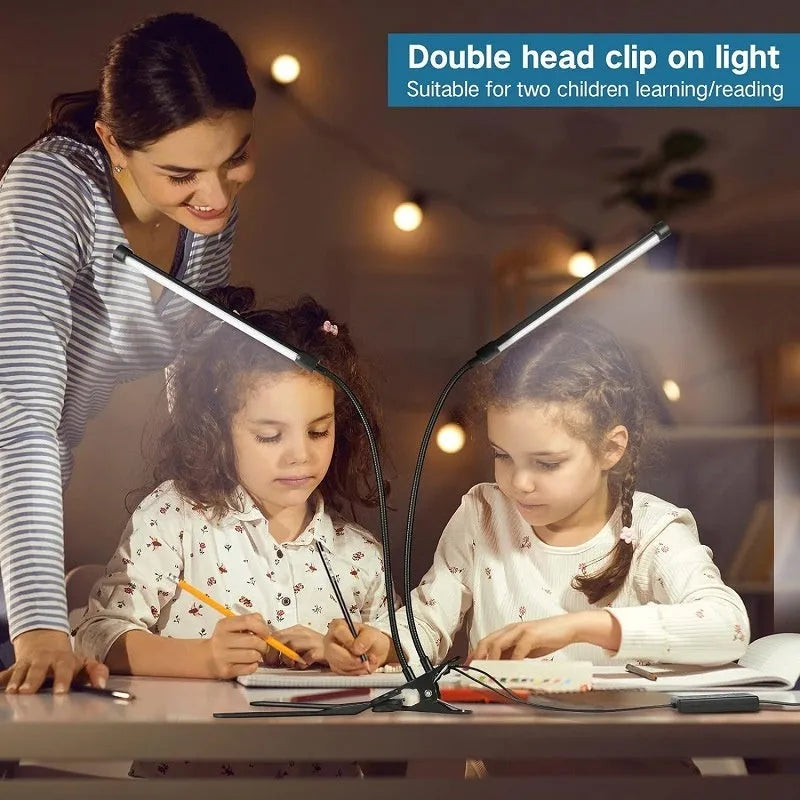 Black and white USB-powered LED desk lamp with a 26 cm long adjustable gooseneck neck on a table.