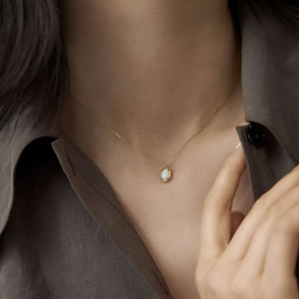 Simple geometric oval jelly opal pendant necklace on S925 silver chain in gold or white gold finish.