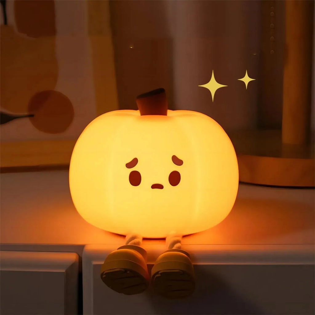 Soft orange silicone pumpkin-shaped night light with a warm glowing LED centre