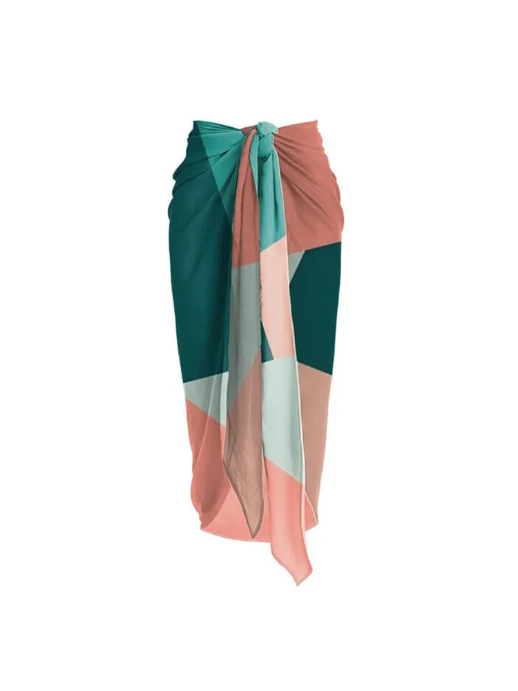 Contrast colour bikini two-piece set with a light mesh gauze skirt laid flat.