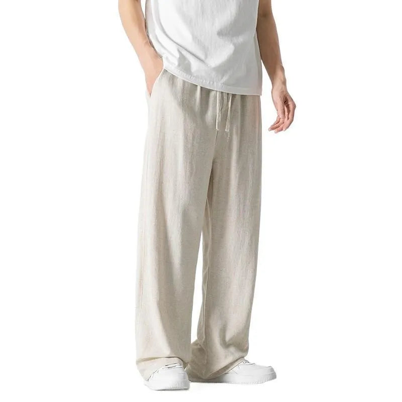 Men's beige cropped linen trousers with a drawstring waist and straight-leg casual style on a hanger.