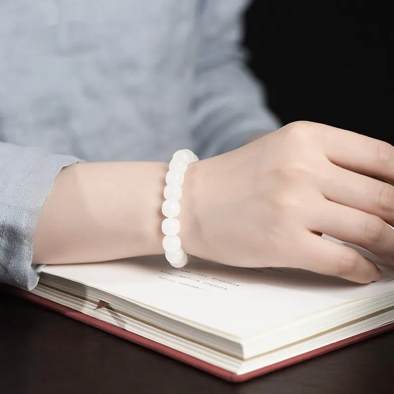 White Hetian jade barrel bead bracelet showing three size options: 5x6mm, 7x8mm, and 8x10mm on a neutral background.