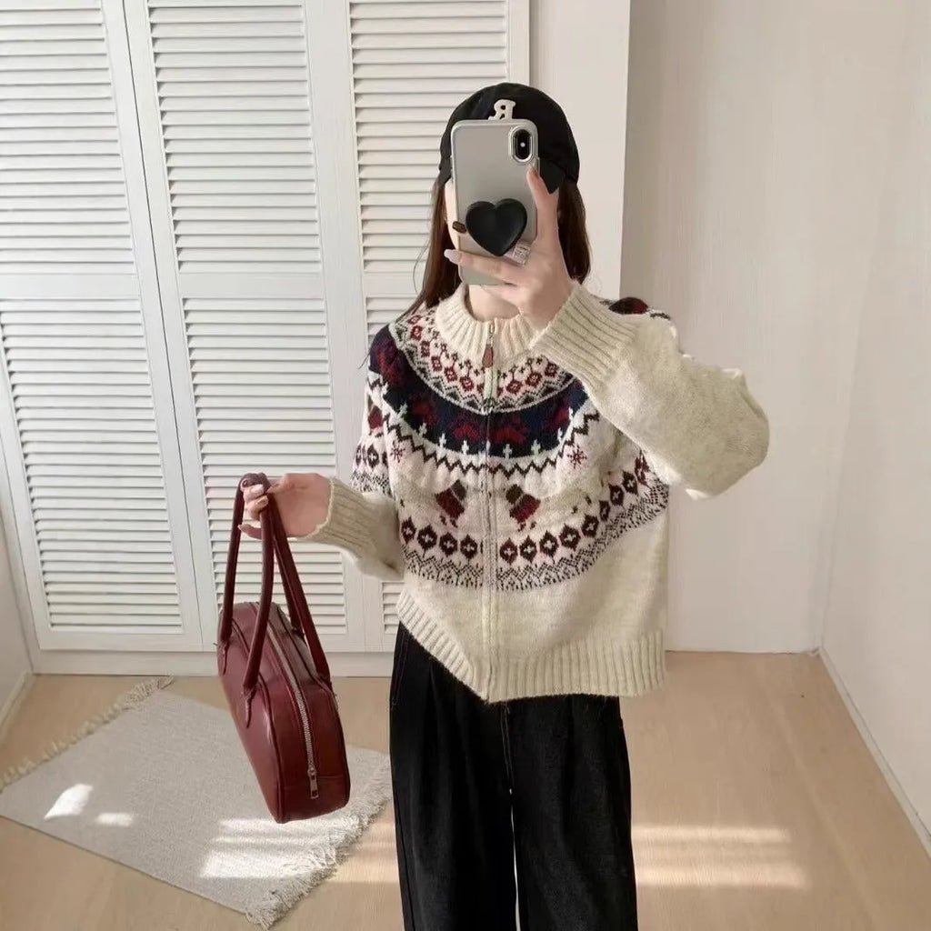Beige ethnic Jacquard pattern pullover sweater with 3D effect and round neck on a hanger.