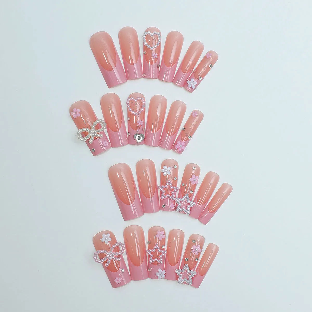 Decorative false nails with extended water pipe French tips, bow detailing and diamond accents in colour XB-70-48