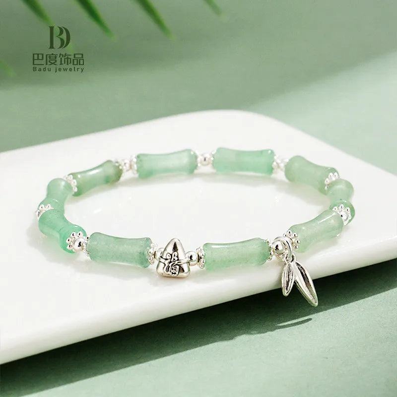 Green aventurine bamboo bead crystal bracelet with strawberry quartz and Dongling stones on wrist.