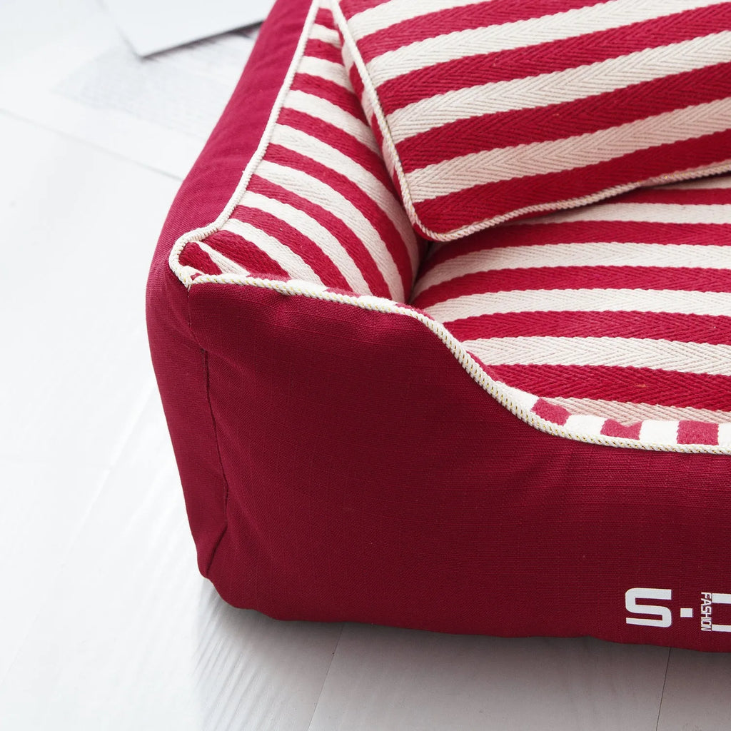 Navy stripes dog crate mat and matching fabric pillow set on a white background.