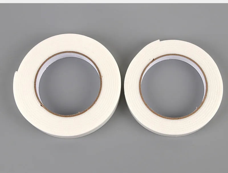 Roll of 3mm thick white foam double-sided adhesive tape showing its spongy core and strong adhesive on both sides.