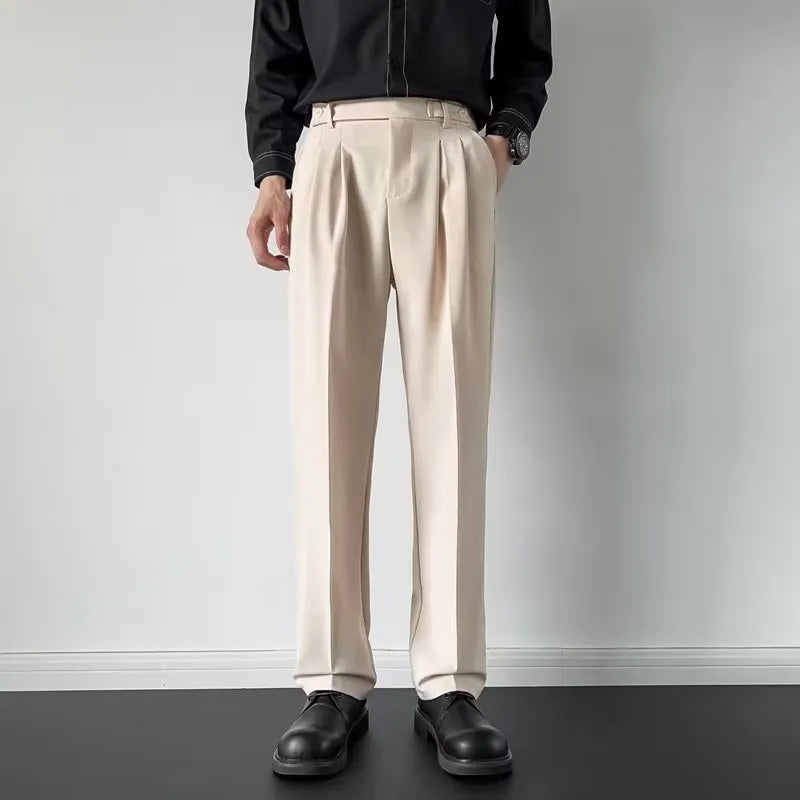 Men's apricot and black straight-leg loose fit suit trousers made from polyester fabric.