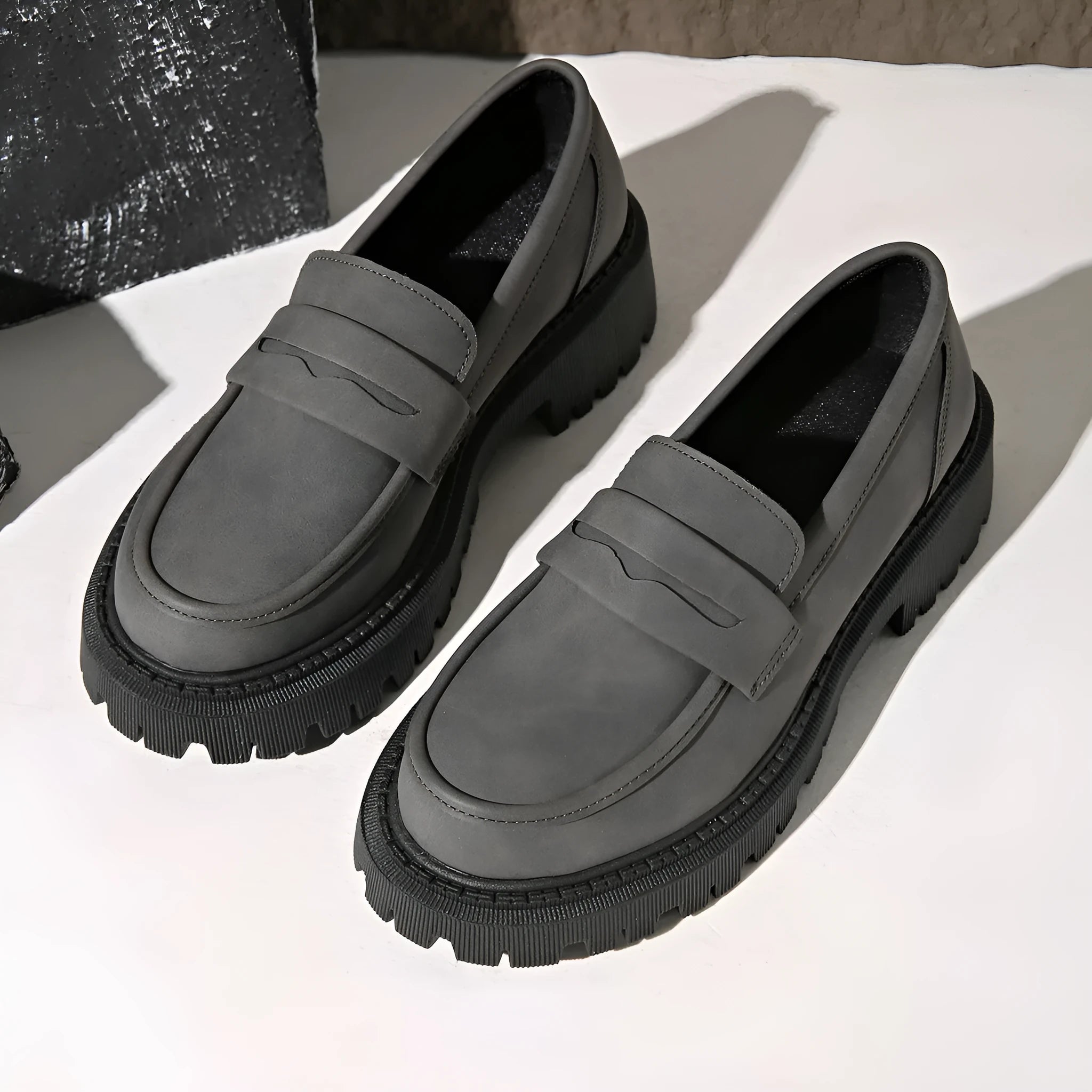 Gray British style slip-on low cut loafers with low heel and rubber sole